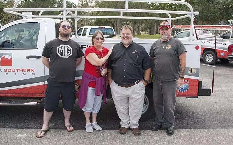Mr. Bostic and his family with Brian Wallace, President of Florida Southern Roofing.